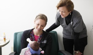 Sheri Smith, RN and Critical Care Services Director at East Tennessee Children's Hospital in Knoxville, TN, visits with Pagie Vantrease, RN, as she feeds a newborn inside it’s room.