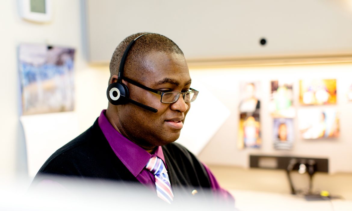 a male staffer at the Peer Recovery Call Center engages with a caller