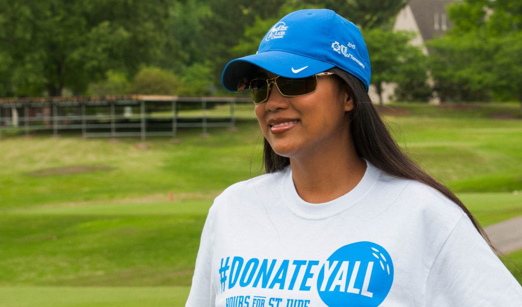 a smiling female volunteer at the St. Jude Classic golf tournament