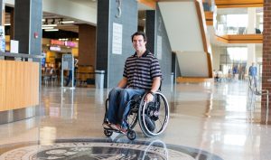 Caleb Wilson poses in his wheelchair.