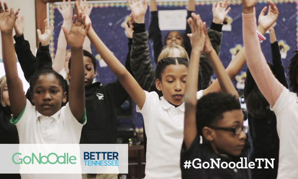 children in a classroom stretching during a GoNoodle exercise