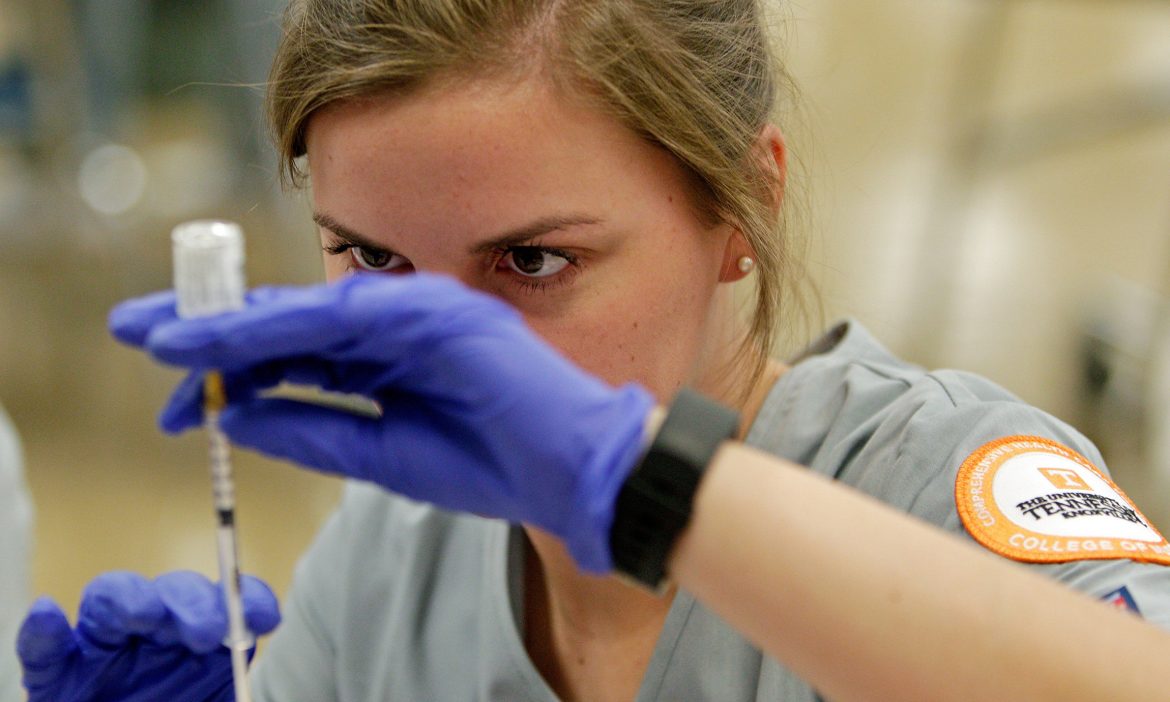 University of Tennessee nursing student Elizabeth Gore fills a syringe before people are allowed in during Free Flu Shot Saturday at Farragut High School Saturday, Oct. 1, 2016, in Knoxville, Tenn. (WADE PAYNE/SPECIAL TO THE NEWS SENTINEL)