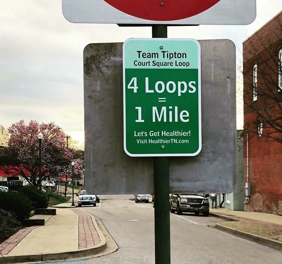 team tipton sign saying 4 loops equals one mile